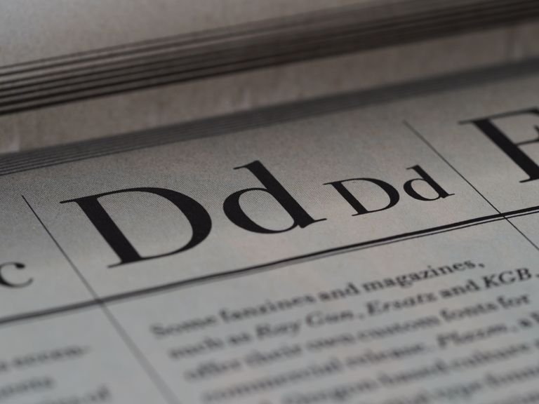 Detailed close-up of a newspaper showing typography and lettering design.